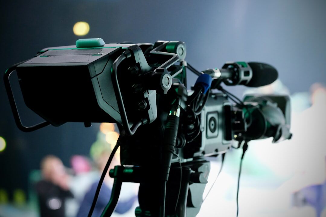 Camera operator filming a live television broadcast in a studio