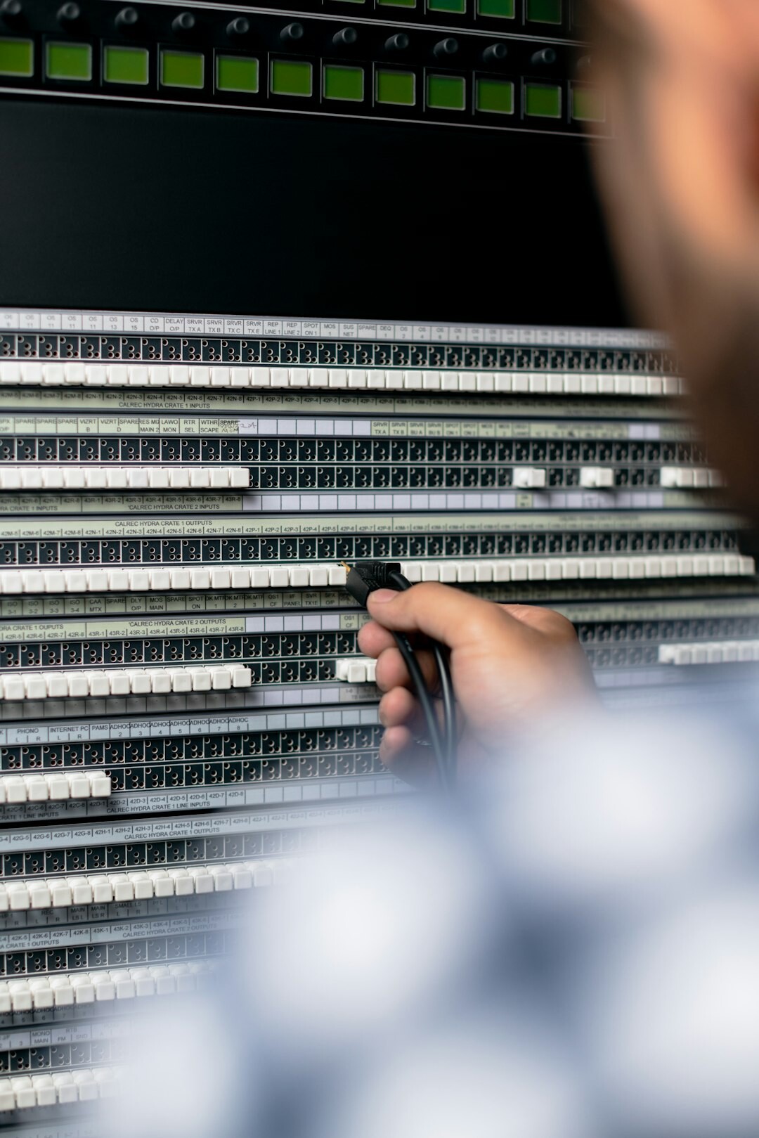 Close-up of a television production mixing console with sliders and knobs